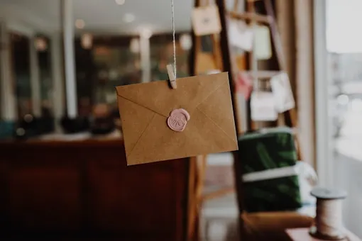 Postcard arriving in a mailbox
